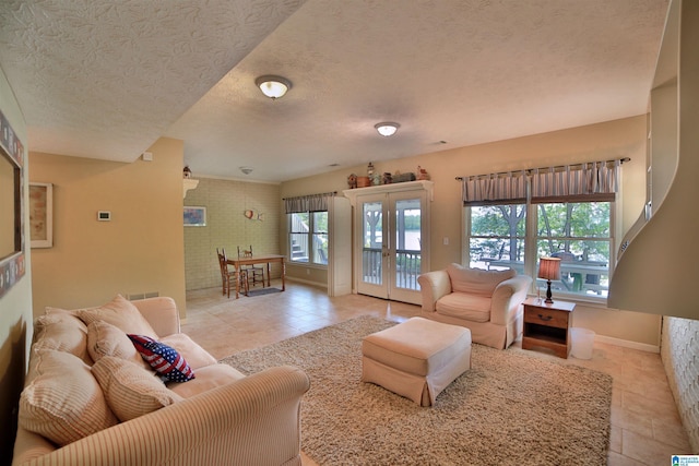 2974 Crescent Crest Dr, Wedowee, AL 36278 - living room featuring light tile patterned flooring, a textured ceiling, baseboards, and french doors