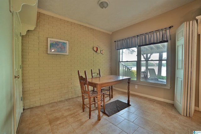2974 Crescent Crest Dr, Wedowee, AL 36278 - dining space with brick wall, crown molding, and an accent wall