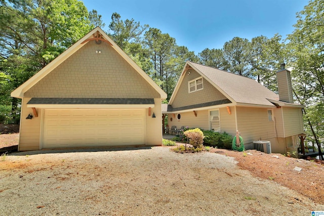 2974 Crescent Crest Dr, Wedowee, AL 36278 - view of front facade featuring a chimney, central air condition unit, a detached garage, and an outdoor structure