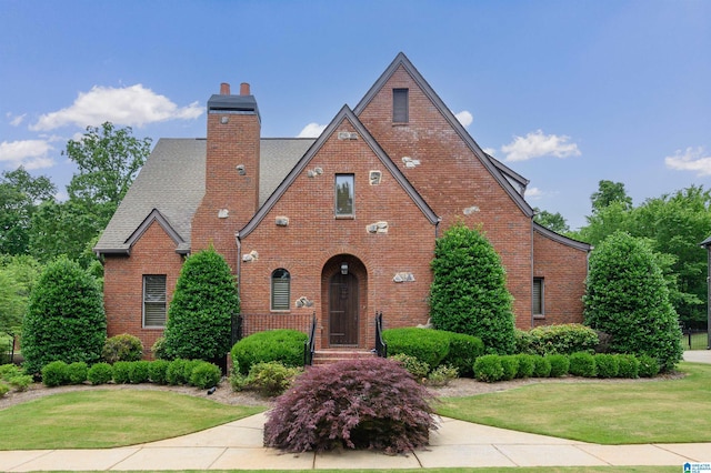 5226 Mountain Ridge Parkway, Birmingham, AL 35222 - tudor home featuring brick siding, a front lawn, a chimney, and roof with shingles