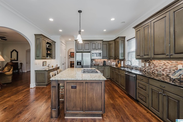 5226 Mountain Ridge Parkway, Birmingham, AL 35222 - kitchen featuring appliances with stainless steel finishes, a sink, arched walkways, dark stone counters, and dark wood finished floors