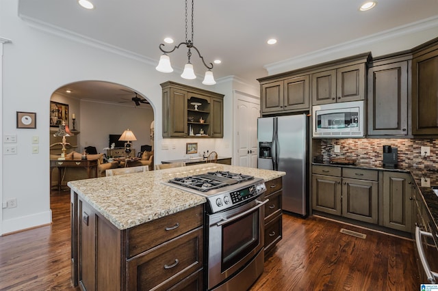 5226 Mountain Ridge Parkway, Birmingham, AL 35222 - kitchen with appliances with stainless steel finishes, arched walkways, dark wood finished floors, backsplash, and light stone countertops
