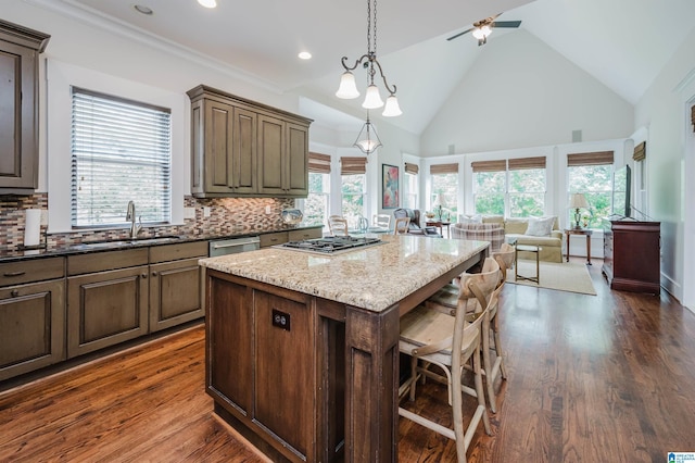 5226 Mountain Ridge Parkway, Birmingham, AL 35222 - kitchen featuring a sink, open floor plan, a kitchen breakfast bar, a kitchen island, and tasteful backsplash