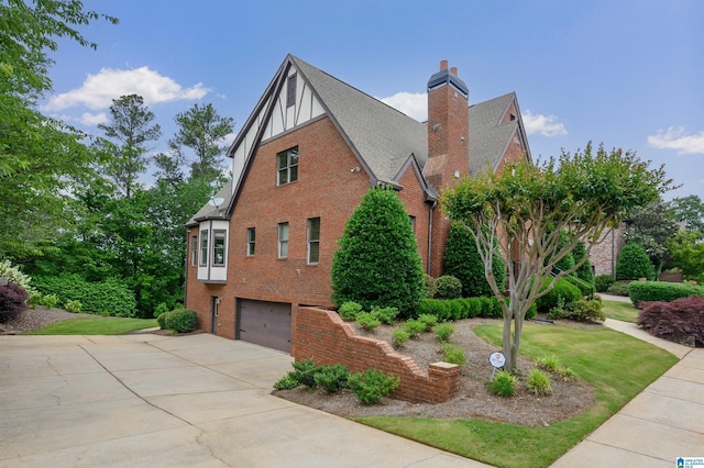 5226 Mountain Ridge Parkway, Birmingham, AL 35222 - view of side of home with driveway, brick siding, an attached garage, a chimney, and a shingled roof