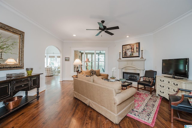 5226 Mountain Ridge Parkway, Birmingham, AL 35222 - living room featuring a glass covered fireplace, a ceiling fan, arched walkways, wood finished floors, and crown molding