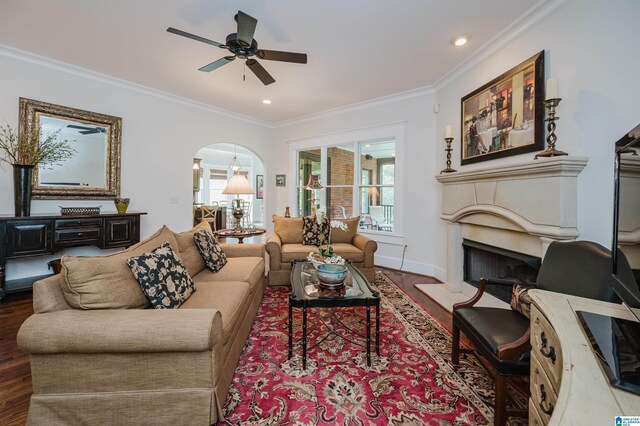5226 Mountain Ridge Parkway, Birmingham, AL 35222 - living area featuring ornamental molding, a ceiling fan, a fireplace with raised hearth, wood finished floors, and arched walkways