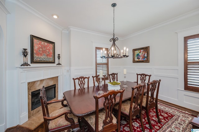 5226 Mountain Ridge Parkway, Birmingham, AL 35222 - dining space featuring ornamental molding, a high end fireplace, a chandelier, wood finished floors, and a decorative wall
