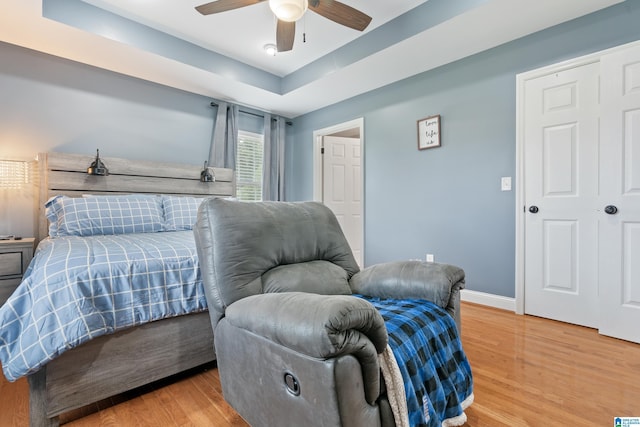 180 Thornberry Dr, Hayden, AL 35079 - bedroom featuring light wood-style floors, baseboards, ceiling fan, and a raised ceiling