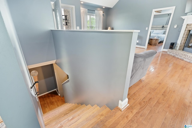 180 Thornberry Dr, Hayden, AL 35079 - staircase featuring wood finished floors, a fireplace, and baseboards