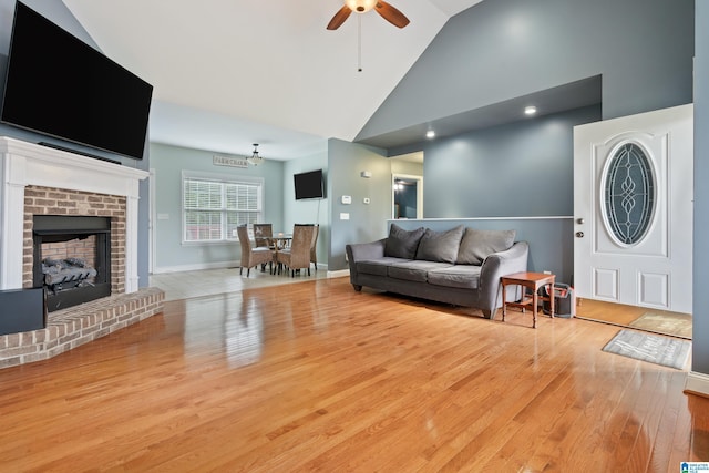 180 Thornberry Dr, Hayden, AL 35079 - living room with ceiling fan, wood finished floors, high vaulted ceiling, a fireplace, and baseboards
