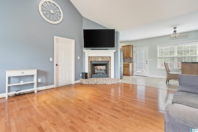 180 Thornberry Dr, Hayden, AL 35079 - living area featuring high vaulted ceiling, baseboards, light wood-style flooring, and a fireplace