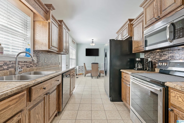 180 Thornberry Dr, Hayden, AL 35079 - kitchen with stainless steel appliances, a sink, tasteful backsplash, light tile patterned floors, and light countertops