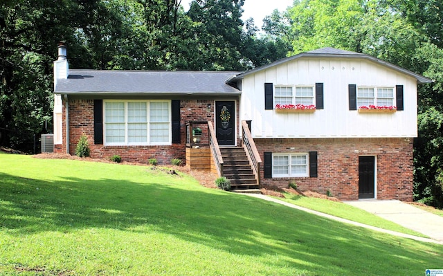 1140 Tribe Trl, Alabaster, AL 35007 - tri-level home with a front yard, brick siding, and a chimney