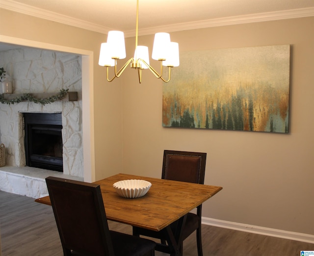 1140 Tribe Trl, Alabaster, AL 35007 - dining area with a chandelier, wood finished floors, ornamental molding, a fireplace, and baseboards