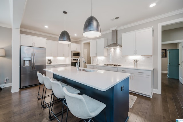 3104 Simms Lndg, Pelham, AL 35124 - kitchen with stainless steel appliances, wall chimney range hood, a sink, a center island with sink, and decorative backsplash