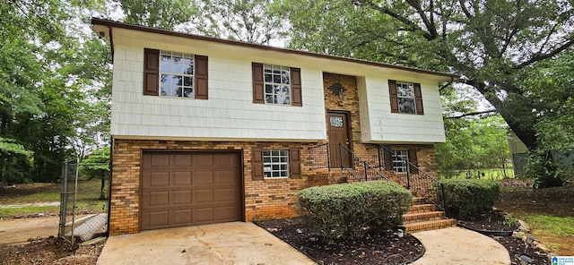 235 Bernard Couch Dr, Anniston, AL 36207 - bi-level home with an attached garage, brick siding, and driveway
