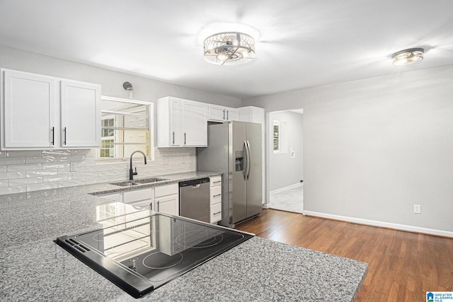 6365 Pocahontas Rd, Bessemer, AL 35022 - kitchen with stainless steel appliances, backsplash, light stone counters, white cabinetry, and dark wood-style floors
