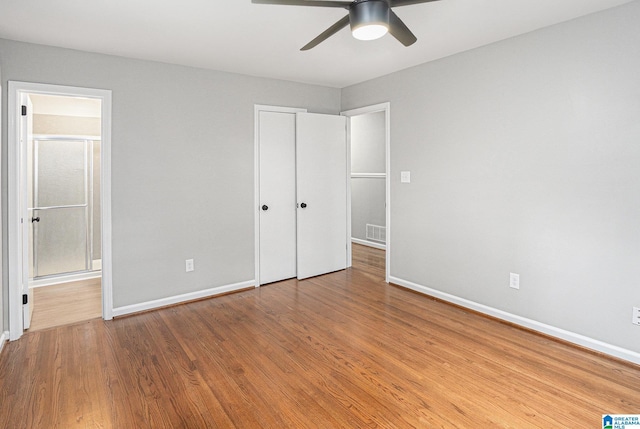 6365 Pocahontas Rd, Bessemer, AL 35022 - unfurnished bedroom with wood finished floors, ensuite bathroom, and ceiling fan