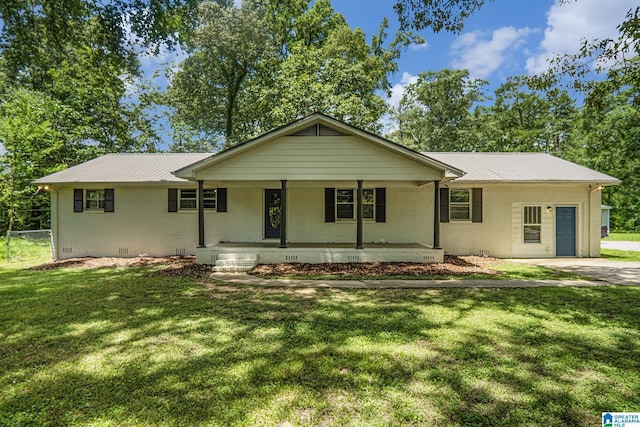 6365 Pocahontas Rd, Bessemer, AL 35022 - ranch-style house with a metal roof, brick siding, covered porch, and a front yard