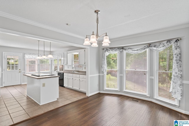 2009 Creely Cir, Birmingham, AL 35235 - kitchen with dishwasher, a chandelier, white cabinets, a kitchen island, and light wood-style floors