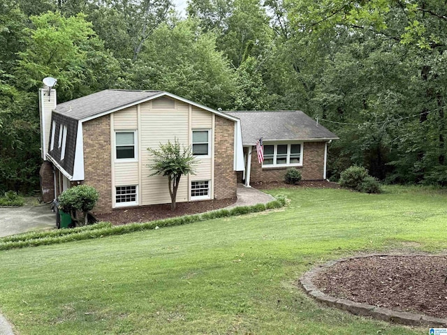 4669 Burning Tree Ln, Pelham, AL 35124 - split level home featuring a front yard, roof with shingles, brick siding, and a chimney