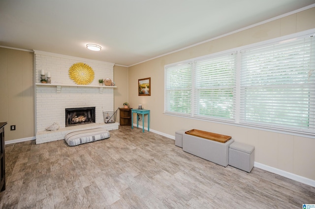 4669 Burning Tree Ln, Pelham, AL 35124 - living room with ornamental molding, a brick fireplace, wood finished floors, and baseboards