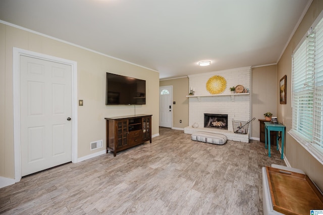 4669 Burning Tree Ln, Pelham, AL 35124 - living room featuring ornamental molding, a brick fireplace, wood finished floors, and baseboards