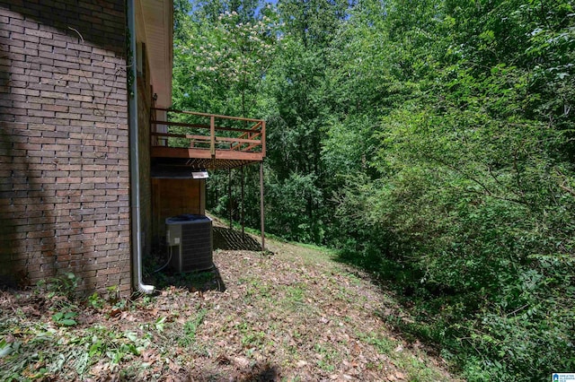 4669 Burning Tree Ln, Pelham, AL 35124 - view of yard with central air condition unit, a view of trees, and a deck