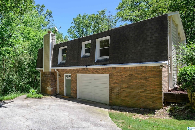 4669 Burning Tree Ln, Pelham, AL 35124 - view of front facade with asphalt driveway, brick siding, roof with shingles, a garage, and a chimney
