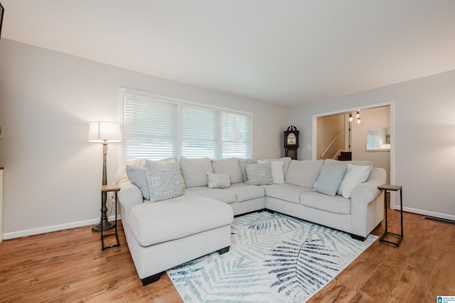 4669 Burning Tree Ln, Pelham, AL 35124 - living area featuring wood finished floors, baseboards, and a chandelier