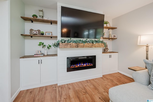4669 Burning Tree Ln, Pelham, AL 35124 - living area with light wood-style flooring, baseboards, and a glass covered fireplace