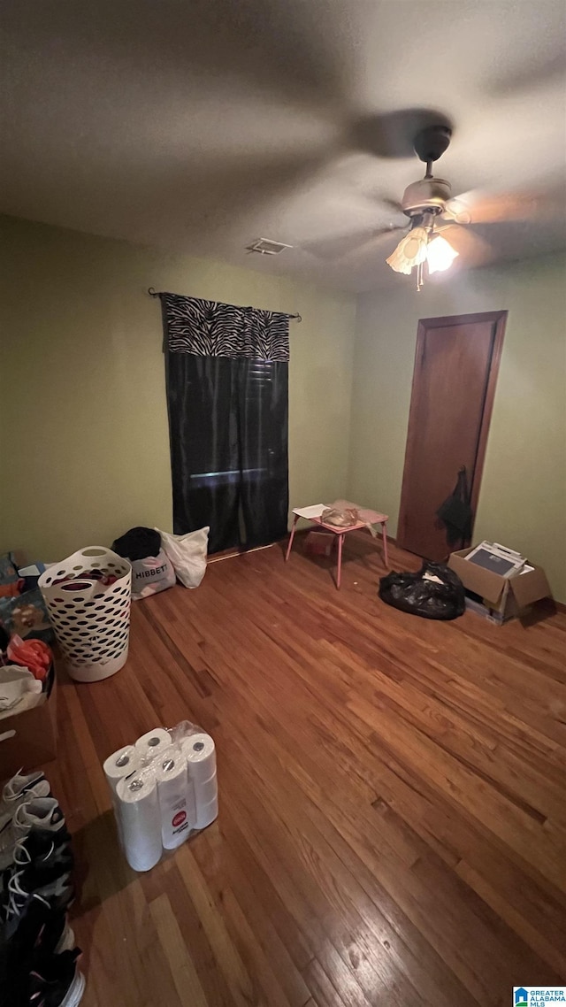 813 W 8th St, Sylacauga, AL 35150 - bedroom with wood finished floors and a ceiling fan