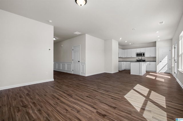 2017 Valley Run, Leeds, AL 35094 - unfurnished living room featuring dark wood-type flooring, baseboards, and recessed lighting