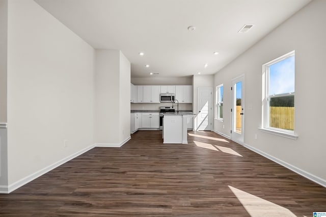 2017 Valley Run, Leeds, AL 35094 - unfurnished living room with baseboards, recessed lighting, dark wood finished floors, and a sink