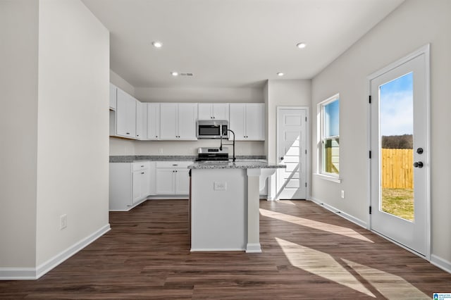 2017 Valley Run, Leeds, AL 35094 - kitchen featuring stainless steel appliances, baseboards, a kitchen island with sink, white cabinetry, and dark wood-type flooring