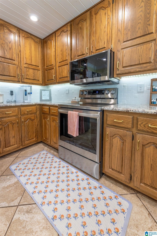 95 River Oaks Ln, Cropwell, AL 35054 - kitchen featuring appliances with stainless steel finishes, decorative backsplash, brown cabinetry, light stone countertops, and recessed lighting