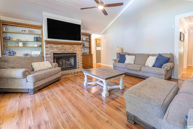 95 River Oaks Ln, Cropwell, AL 35054 - living room featuring lofted ceiling, ceiling fan, light wood-style flooring, baseboards, and a brick fireplace