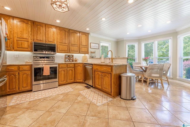 95 River Oaks Ln, Cropwell, AL 35054 - kitchen featuring appliances with stainless steel finishes, crown molding, brown cabinets, a peninsula, and a sink