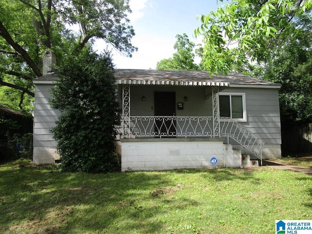 1782 49th St, Birmingham, AL 35208 - bungalow with a porch, a front yard, roof with shingles, and a chimney