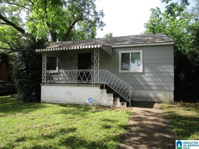 1782 49th St, Birmingham, AL 35208 - view of front of house featuring a porch, a shingled roof, and a front lawn