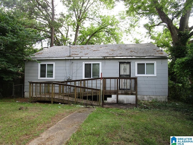 1782 49th St, Birmingham, AL 35208 - view of front of house with a wooden deck, roof with shingles, and a front lawn