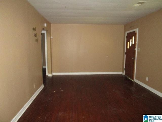 1782 49th St, Birmingham, AL 35208 - spare room with wood finished floors, arched walkways, and baseboards