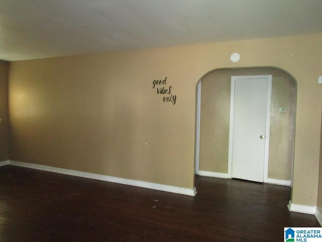 1782 49th St, Birmingham, AL 35208 - unfurnished room featuring arched walkways, dark wood-type flooring, and baseboards