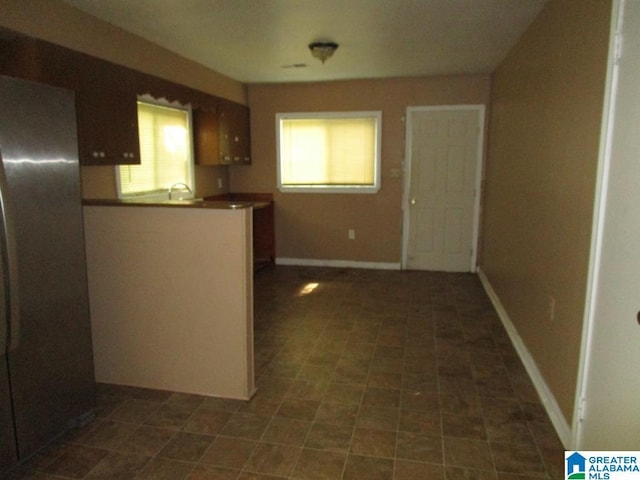 1782 49th St, Birmingham, AL 35208 - kitchen featuring freestanding refrigerator and dark tile patterned floors