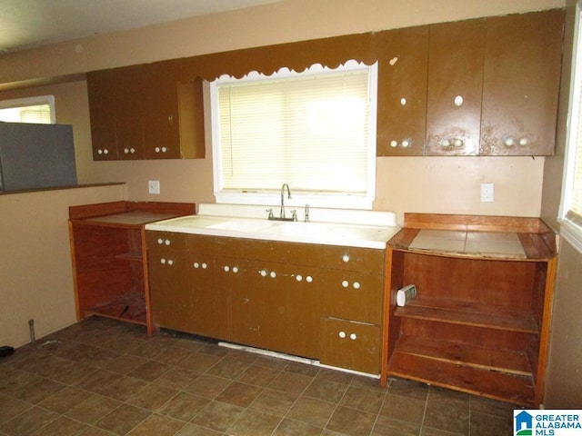 1782 49th St, Birmingham, AL 35208 - kitchen featuring brown cabinets and a sink