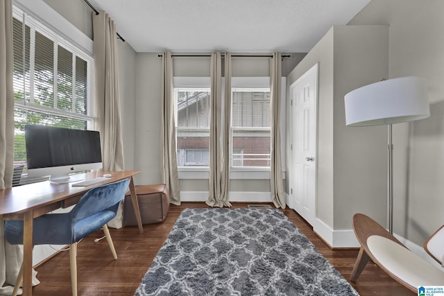 office area with healthy amount of natural light, dark wood finished floors, and baseboards