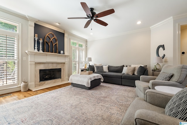 1048 Eagle Hollow Dr, Birmingham, AL 35242 - living area featuring plenty of natural light, a ceiling fan, wood finished floors, a high end fireplace, and ornamental molding