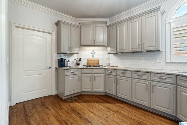 1048 Eagle Hollow Dr, Birmingham, AL 35242 - kitchen with gray cabinetry, wood finished floors, healthy amount of natural light, backsplash, and crown molding