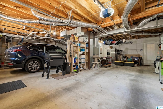 1048 Eagle Hollow Dr, Birmingham, AL 35242 - garage with a garage door opener and stainless steel fridge with ice dispenser
