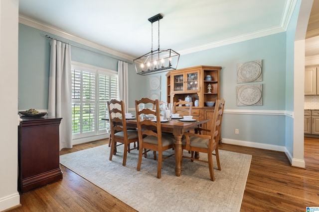 1048 Eagle Hollow Dr, Birmingham, AL 35242 - dining area with a chandelier, crown molding, dark wood-type flooring, and baseboards